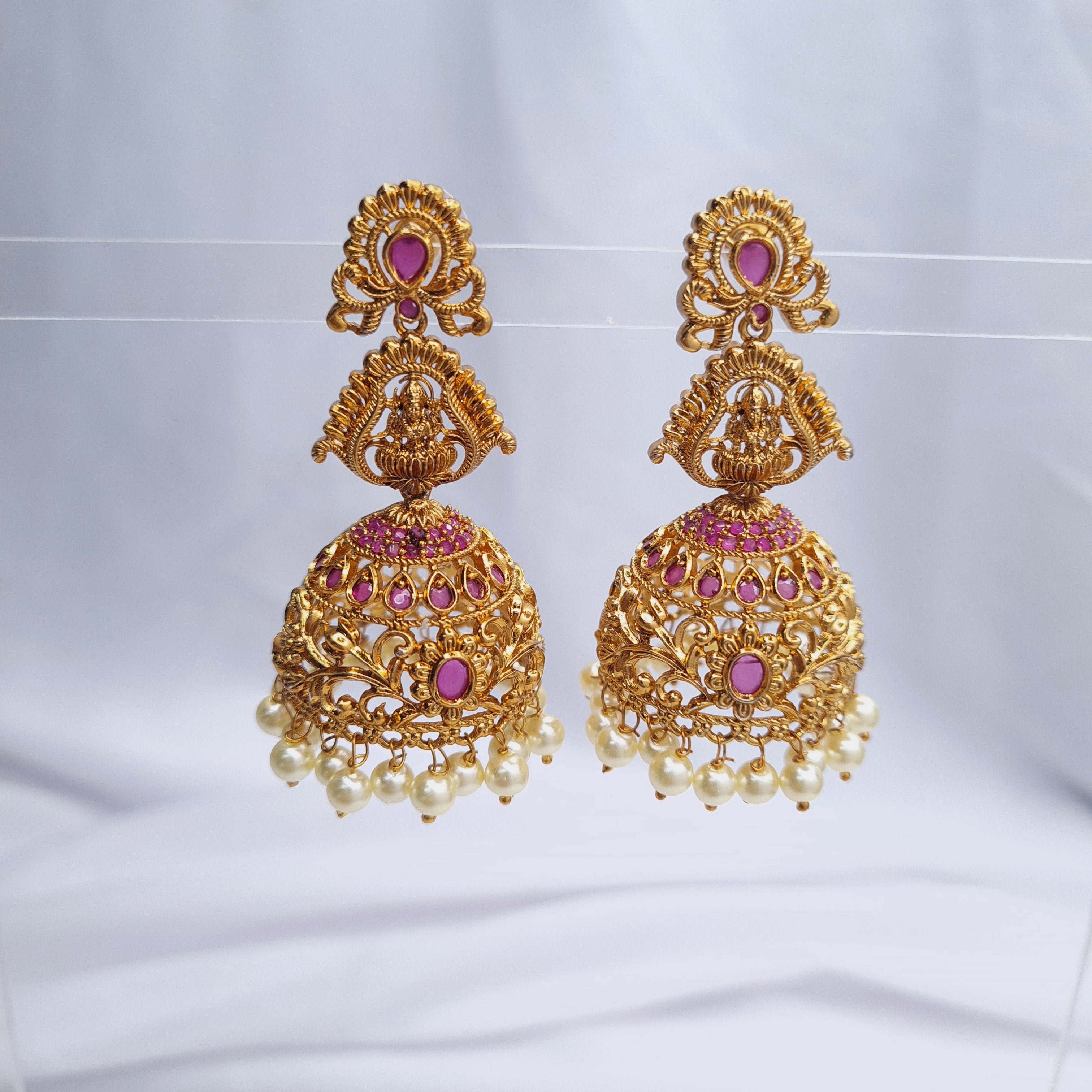 Gold plated copper jhumka earrings with traditional design