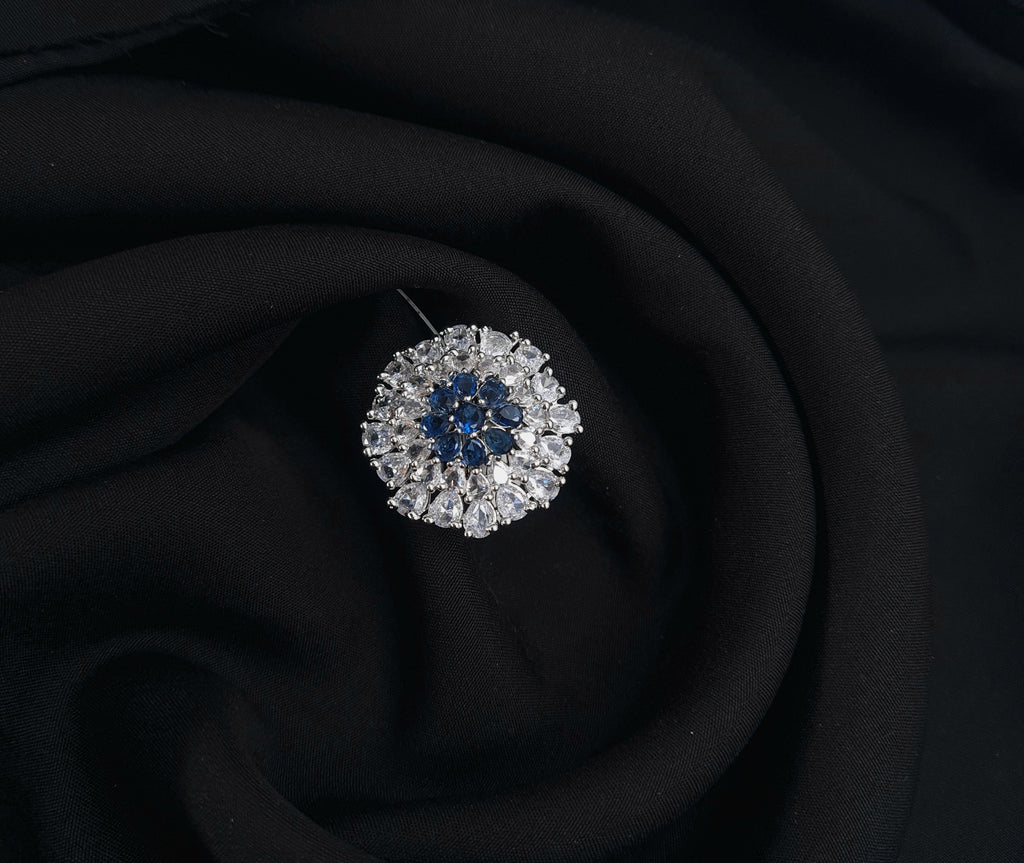 Adjustable silver CZ ring with deep blue center stone

