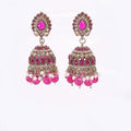 Traditional pink Kundan jhumka earrings with pearl drops and antique finish

