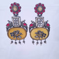 Oxidized earrings with red stone top, peacock design, yellow enamel floral base and bead drops

