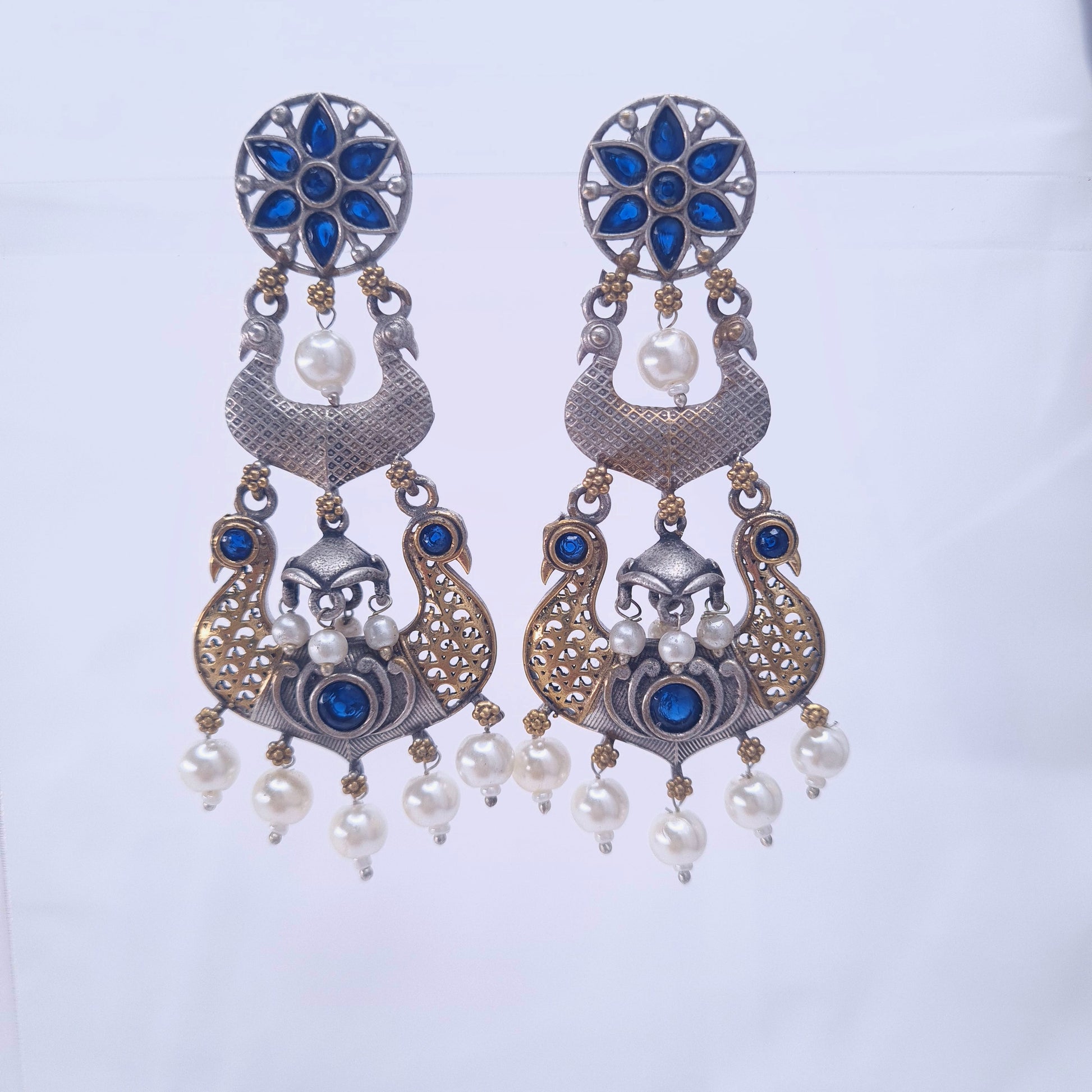Dual-tone oxidized peacock earrings with blue stones and pearl hangings

