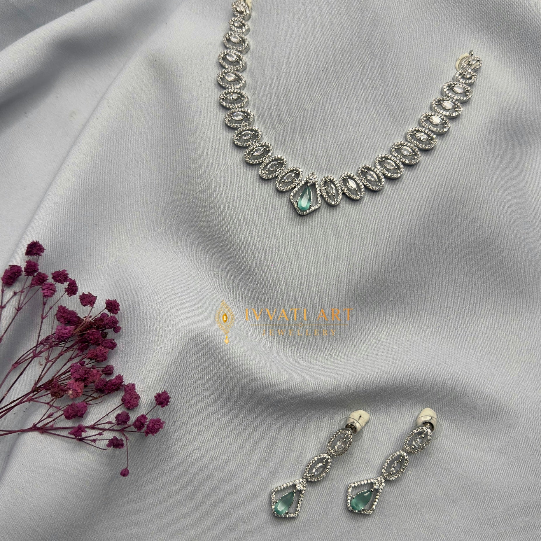Emerald green infinity design diamond silver necklace set with matching earrings – handcrafted festive jewellery by Ivvati Art Jewellery.