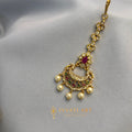 Antique gold crescent maang tikka with ruby-emerald stones and pearl drops – handcrafted festive jewellery by Ivvati Art Jewellery.