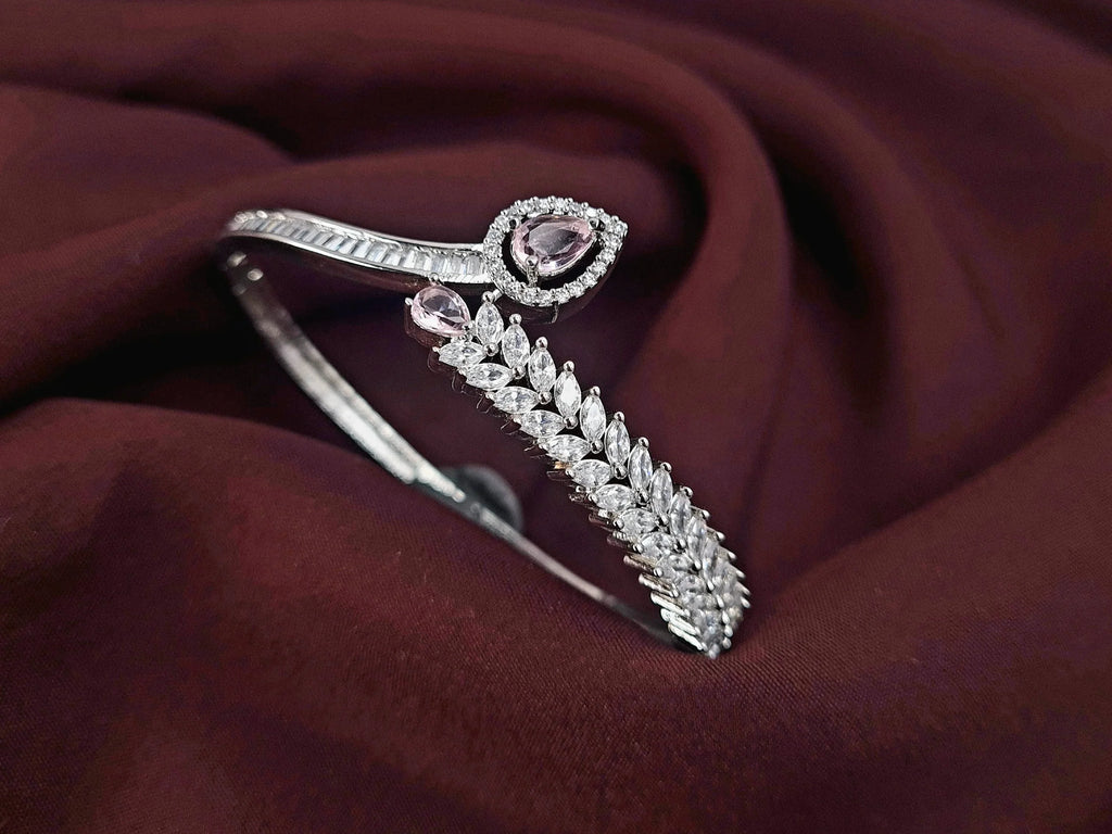 Gold finish CZ bracelet with pink stone centerpiece

