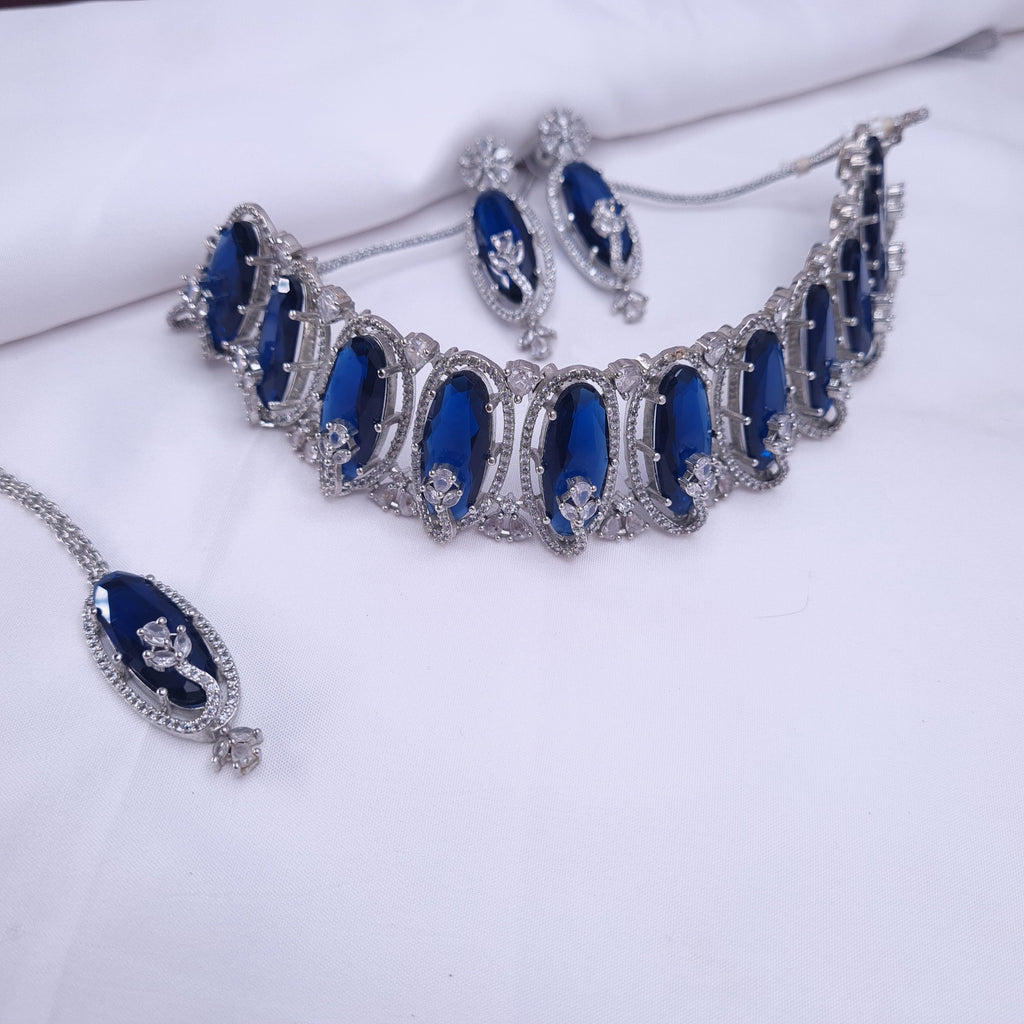 Blue CZ necklace set with oval-shaped stones and floral detailing

