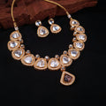 Uncut polki choker necklace set with pear-shaped stones and gold finish, paired with matching earrings

