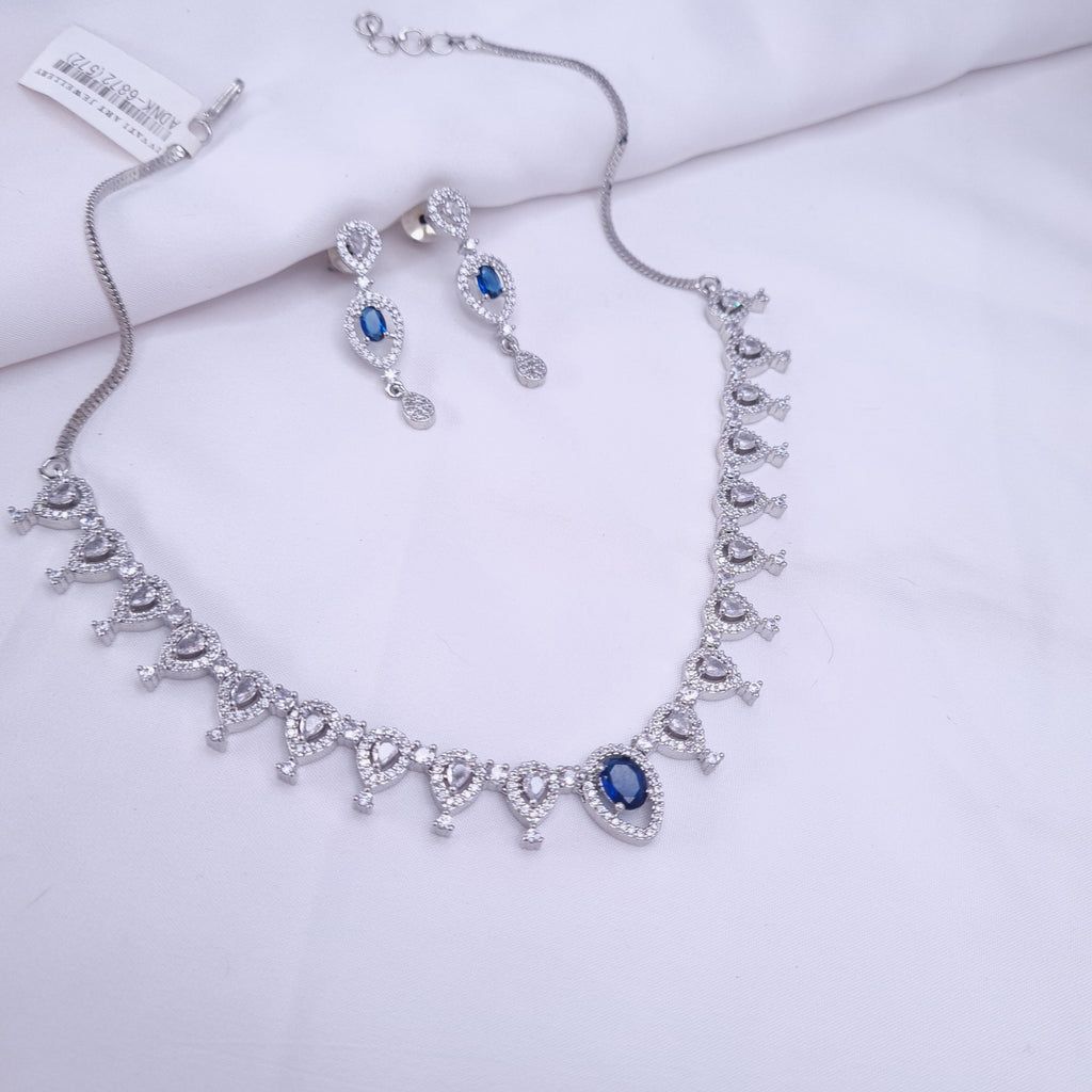 Silver CZ necklace with blue center stone and crystal accents

