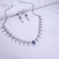 Silver CZ necklace with blue center stone and crystal accents

