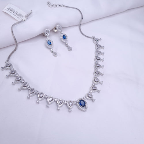 Silver CZ necklace with blue center stone and crystal accents

