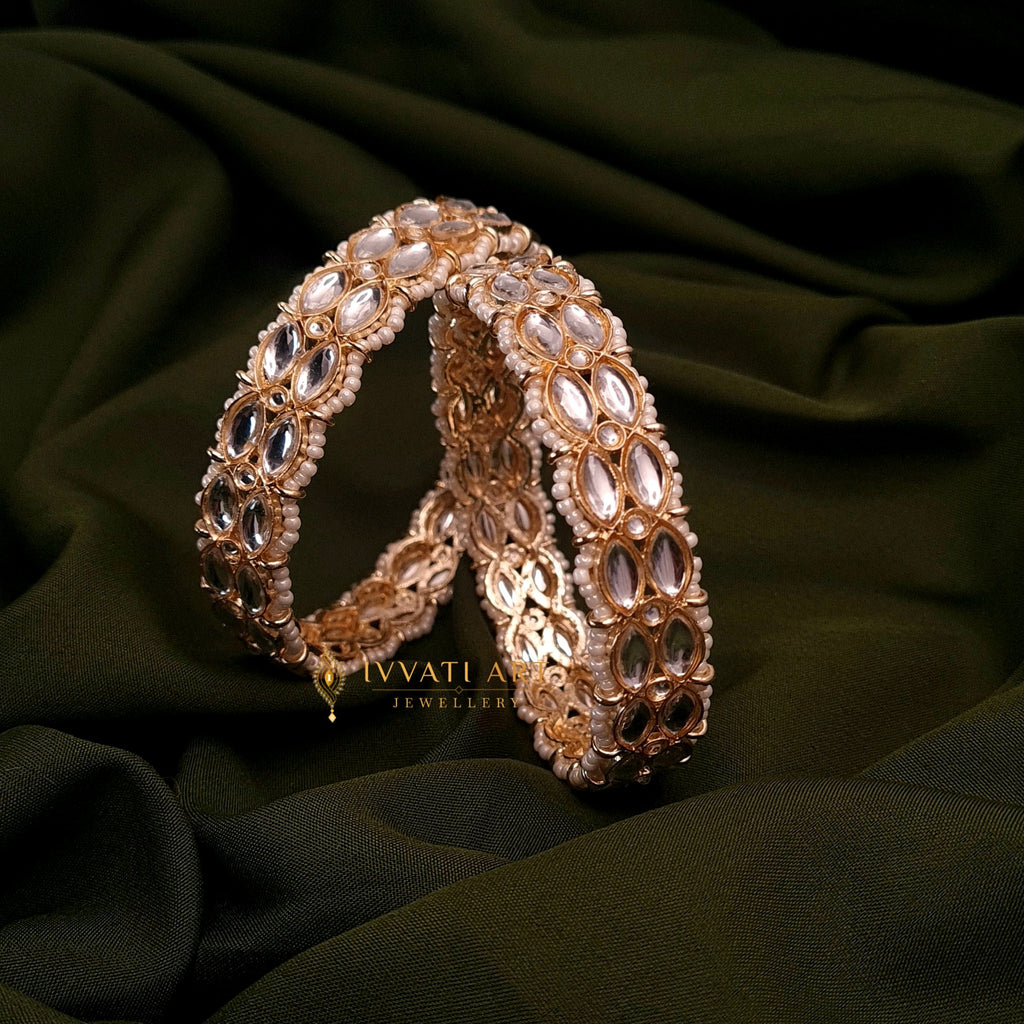 Gold-plated kundan kada bangles with pearls by Ivvati Art Jewellery

