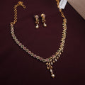 South Indian copper haram necklace set with floral design and AD stones

