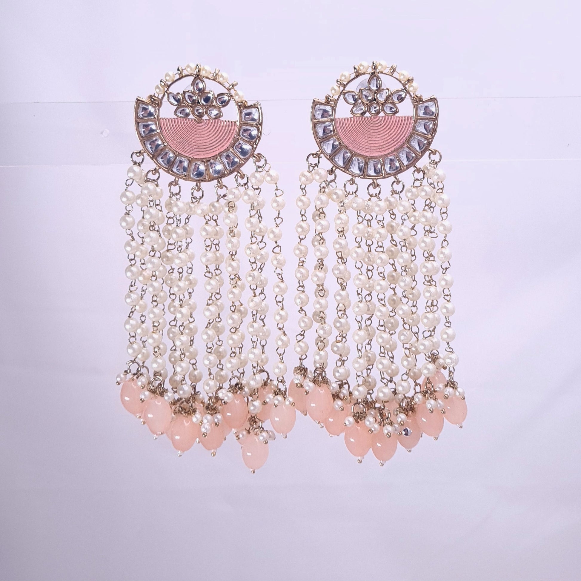 Long traditional kundan earrings with gold finish and intricate design

