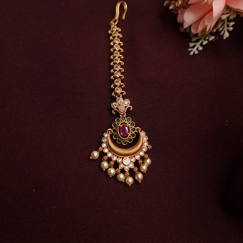 Traditional Indian bridal tikka with antique copper and pearl detailing