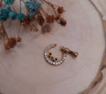 Small gold nose ring with CZ diamond studs in minimal design

