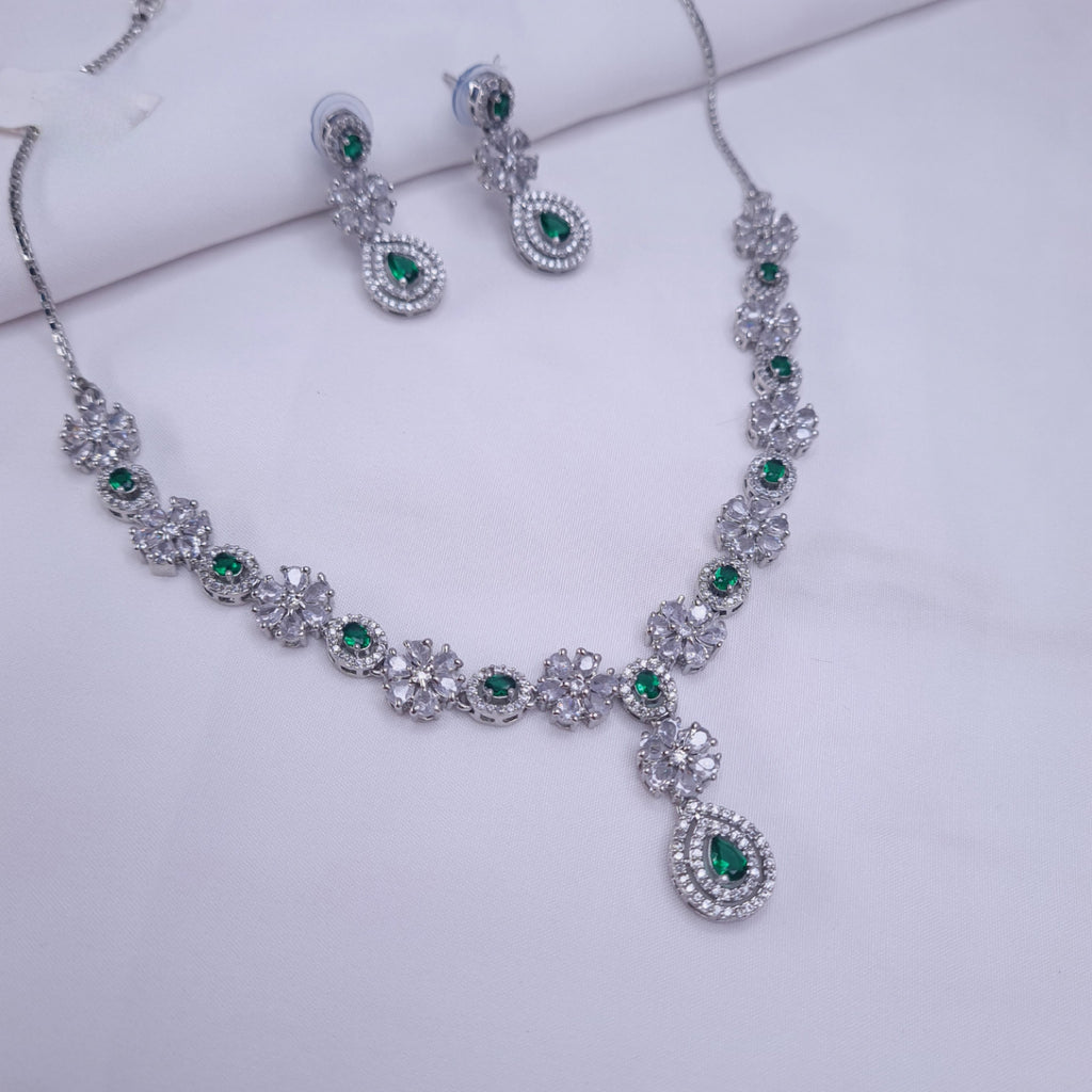 CZ silver necklace with emerald green stones and drop detailing


