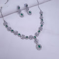 CZ silver necklace with emerald green stones and drop detailing

