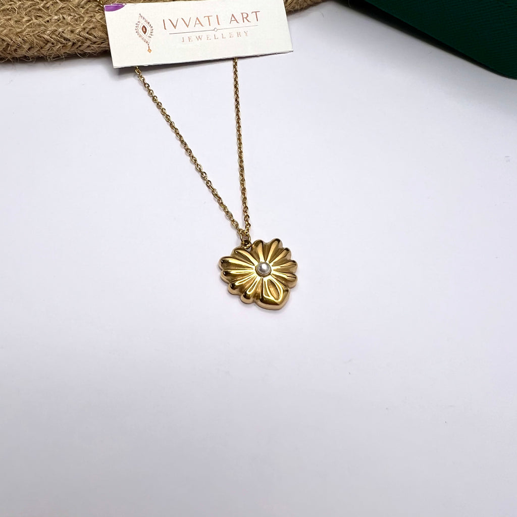 Gold daisy pendant necklace with pearl center on white background – 18K gold-plated

