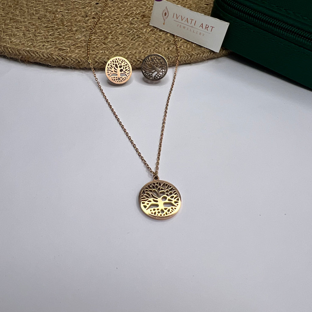 Rose gold tree of life necklace with matching stud earrings on white background

