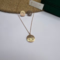 Rose gold tree of life necklace with matching stud earrings on white background

