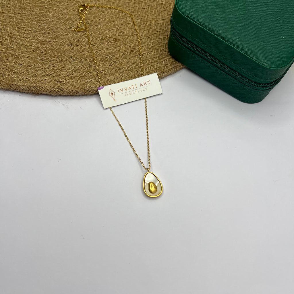 18K gold-plated half egg-shaped pendant necklace on white fabric background

