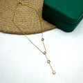 18K gold plated drop necklace with four circular CZ stones on a white cloth background

