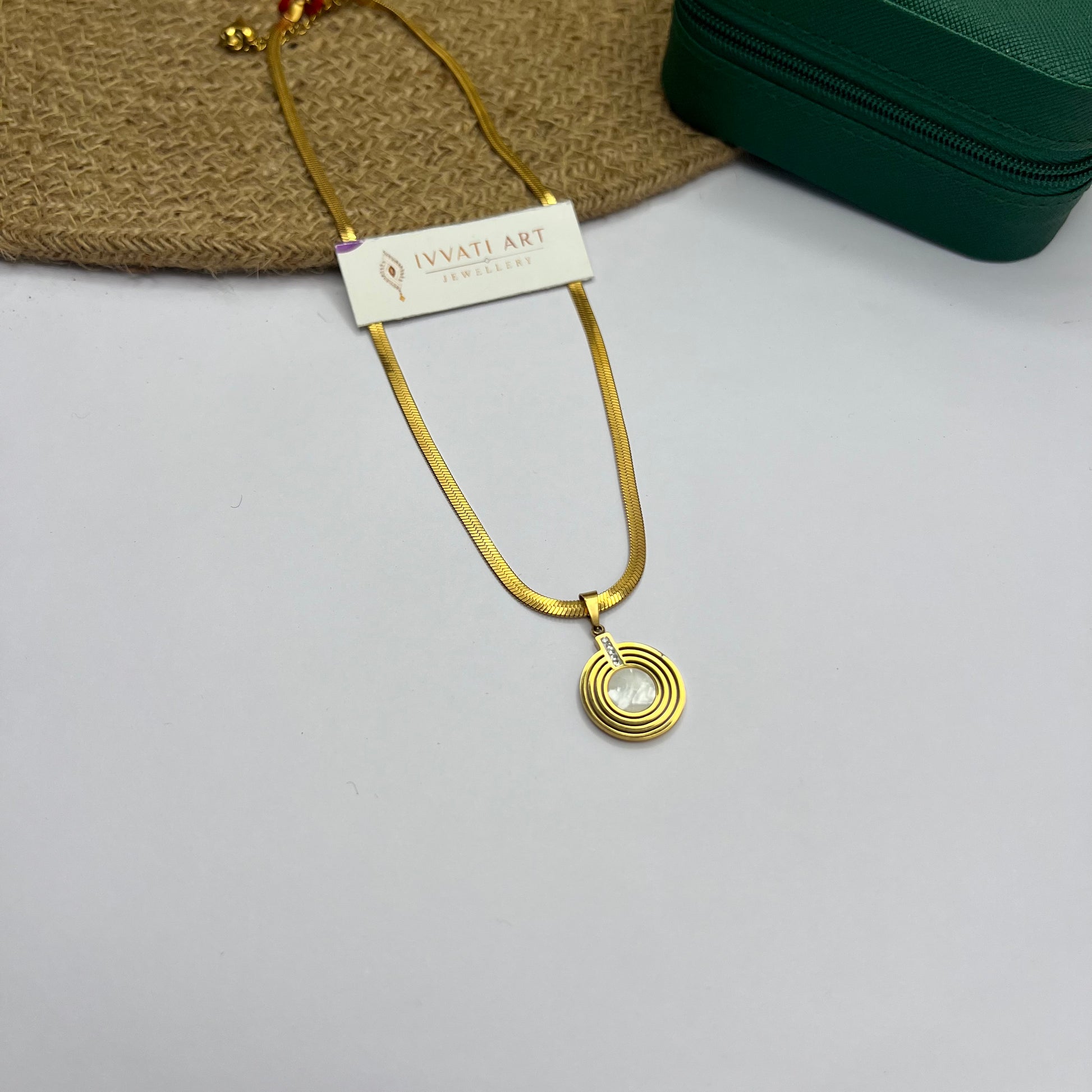 Gold snake chain necklace with concentric circle pendant and white stone center – Lunar Orbit Necklace by Ivvati

