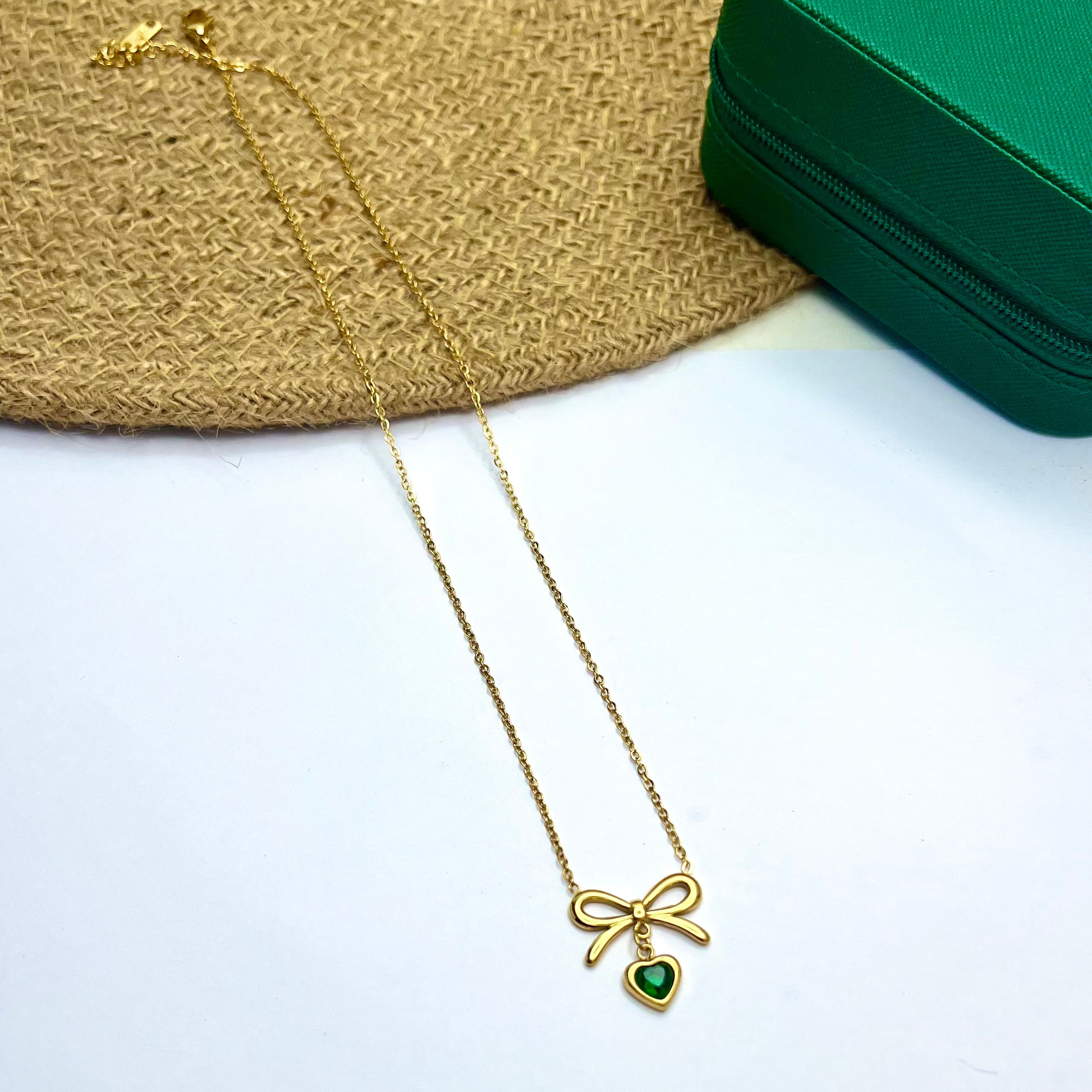 Gold bow pendant necklace with green heart-shaped emerald – Emerald Grace Necklace by Ivvati


