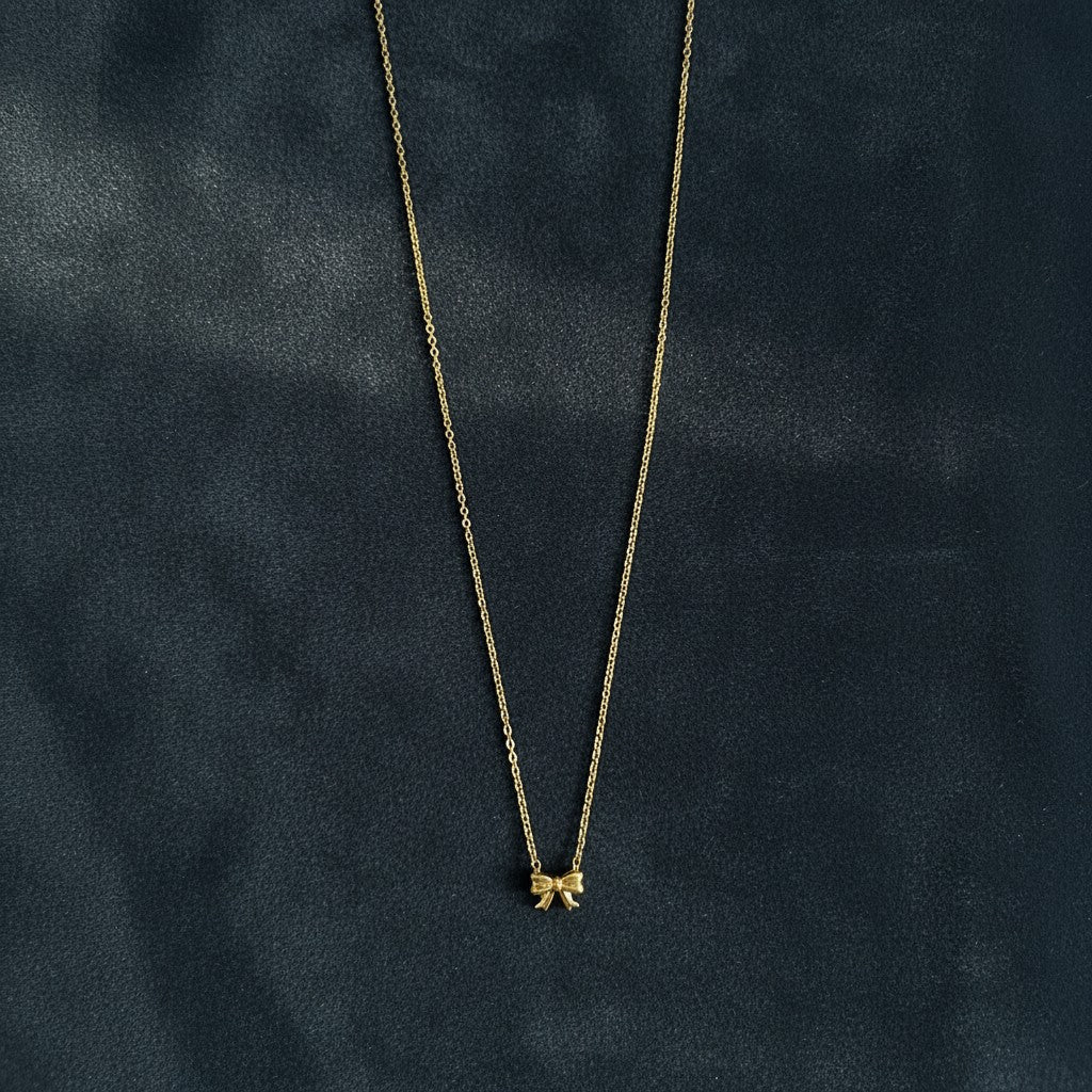 Delicate gold bow pendant necklace with fine chain for women