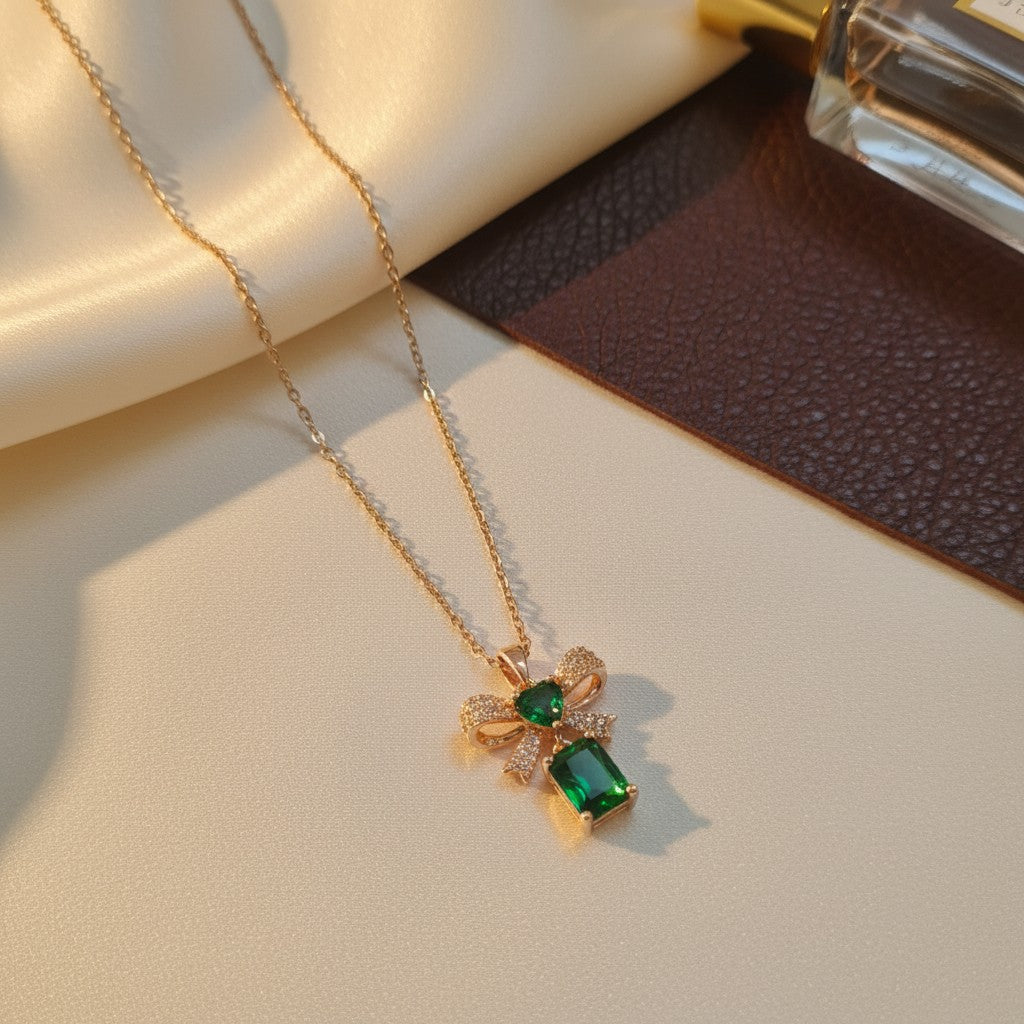 Gold bow necklace with emerald green stone pendant for women