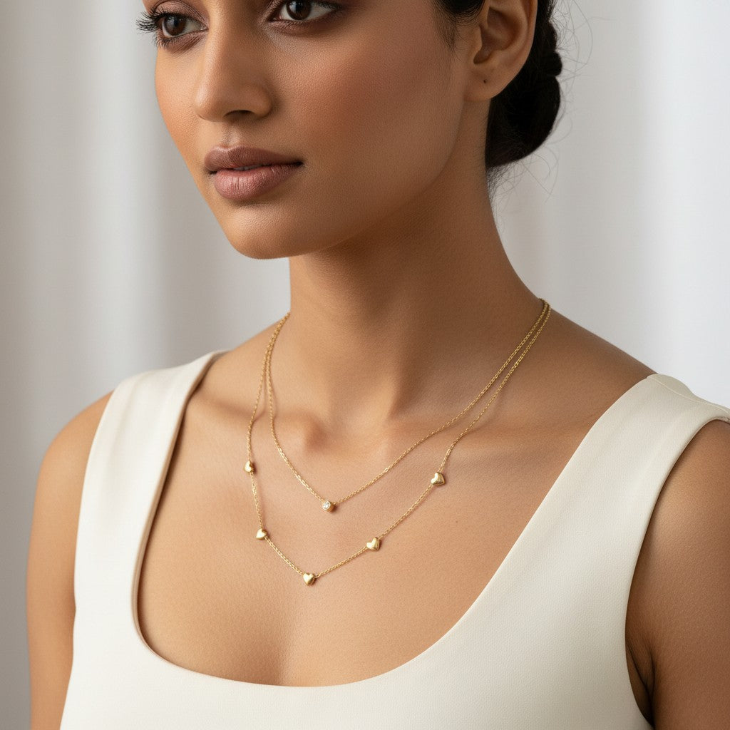 Gold layered necklace for women featuring multiple heart-shaped charms and delicate chains | Ivvati Art Jewellery
