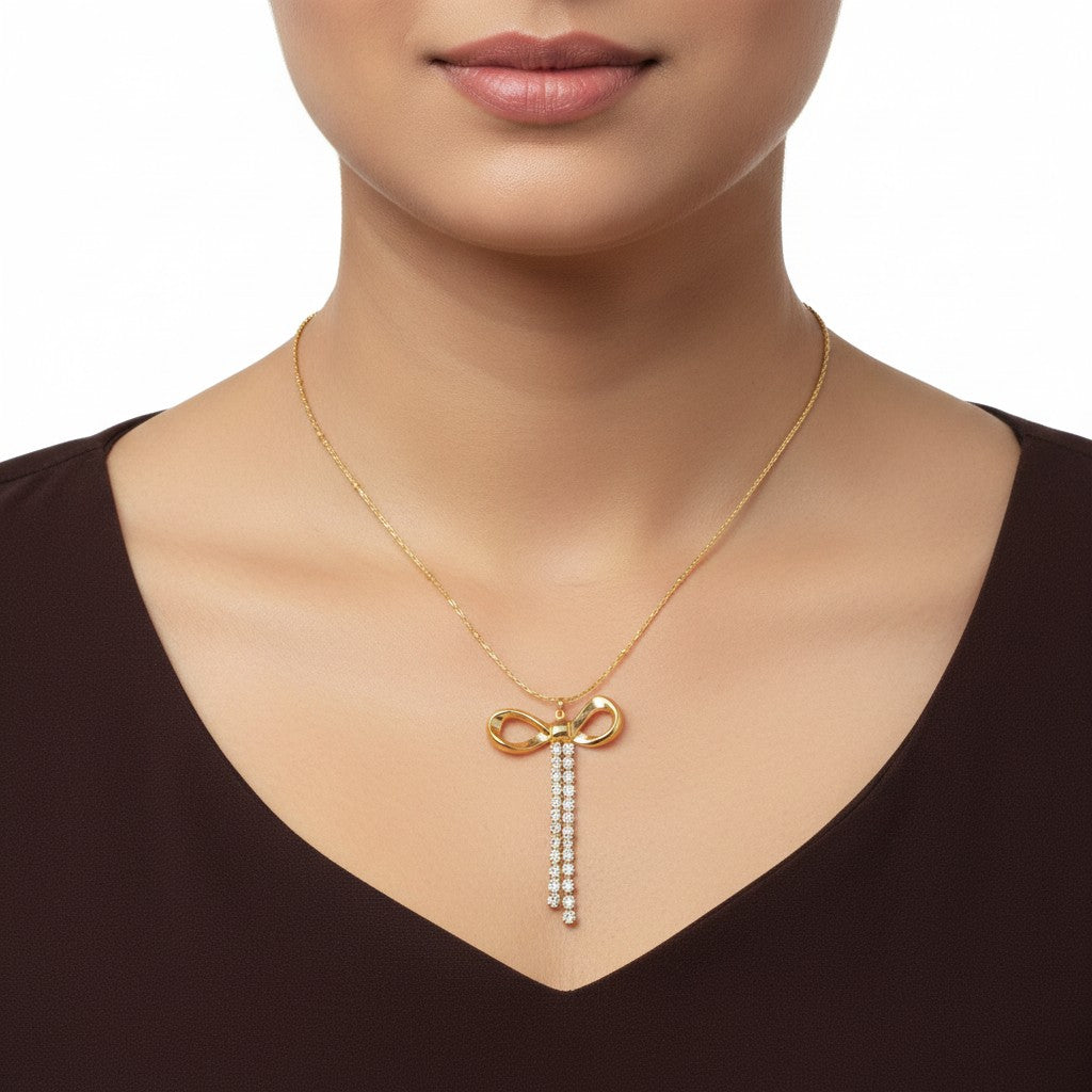 Gold infinity bow necklace with sparkling crystal stone drop