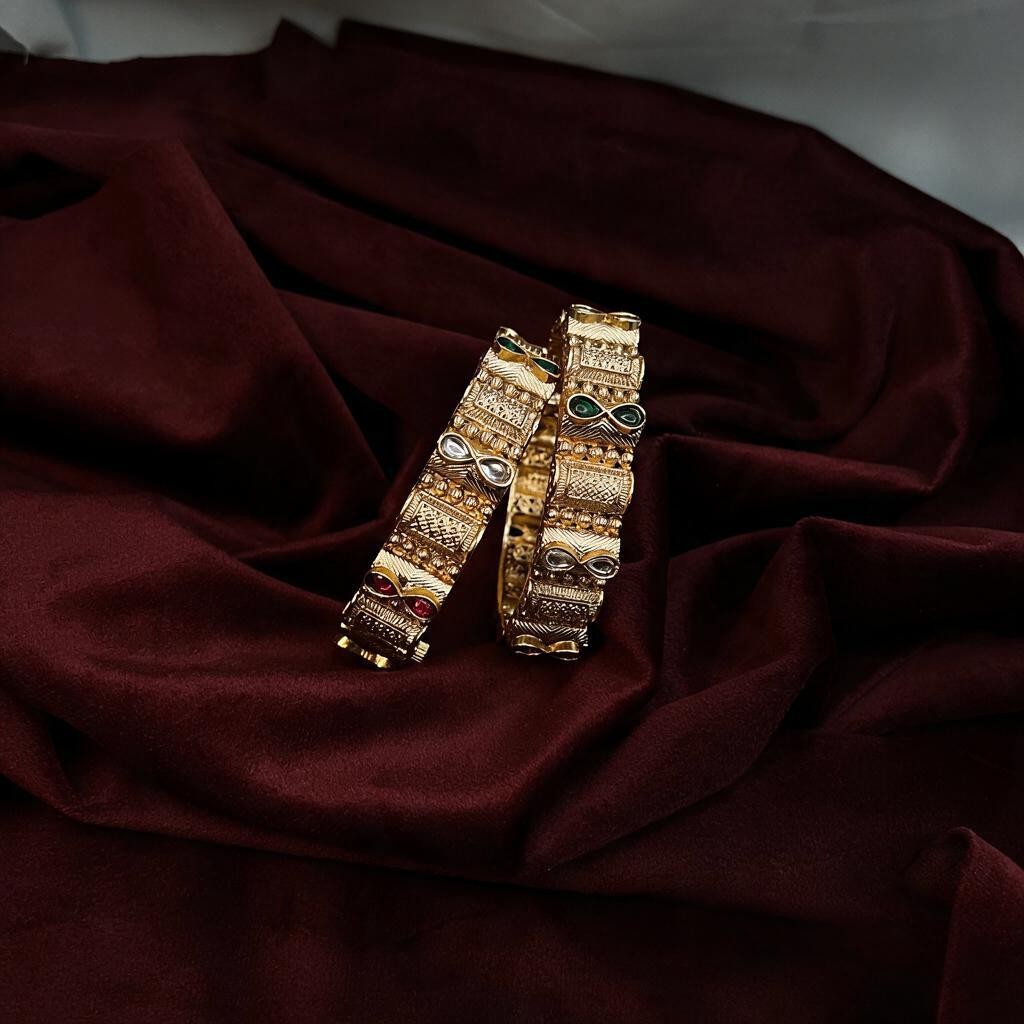 Ivvati gold-tone Rajwadi bangle pair with traditional red and green stone accents