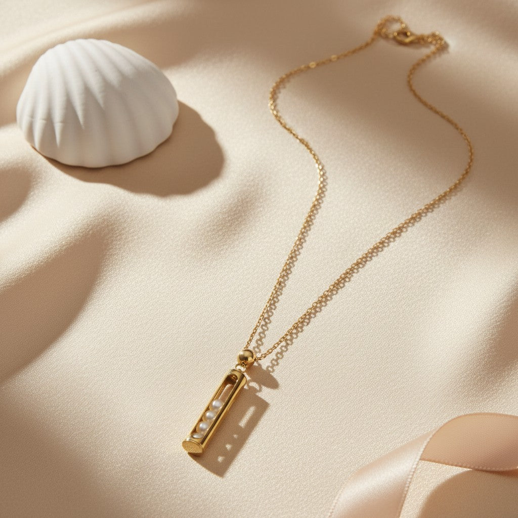 Gold pearl pendant necklace for women with rectangular bar pendant and white pearl detailing | Ivvati Art Jewellery