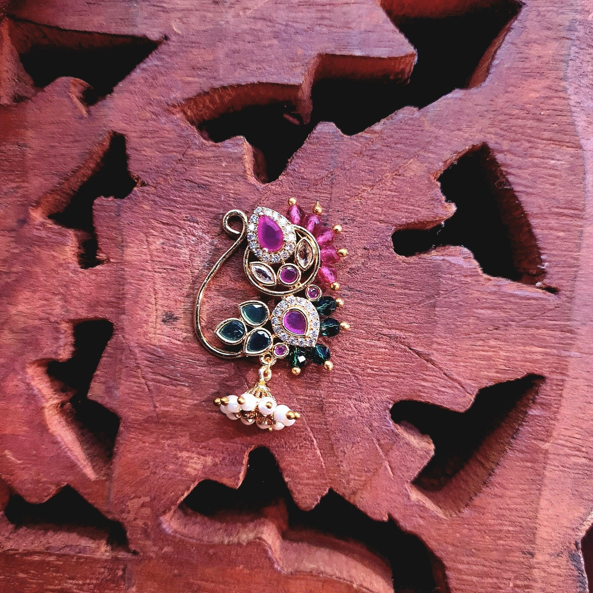 Traditional gold finish stone Nath with red green detailing and pearl drops by Ivvati